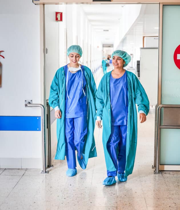 Two students walking out of a hospital wing.