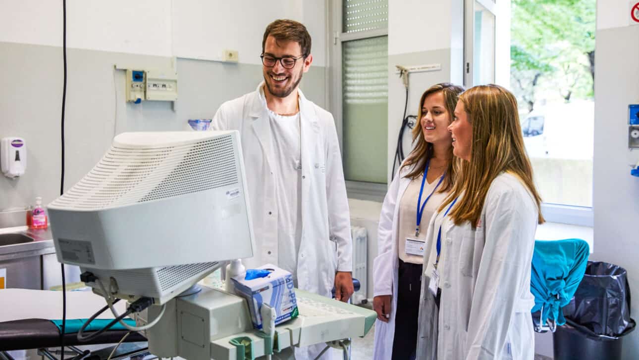 Students watching a doctor use medical equipment