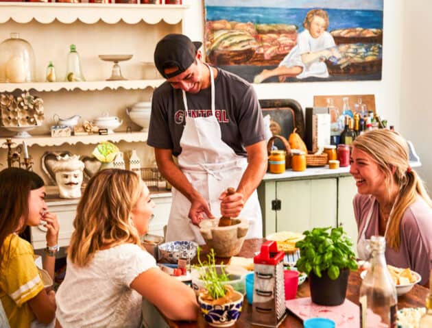 Students learning how to make pesto in Italy.