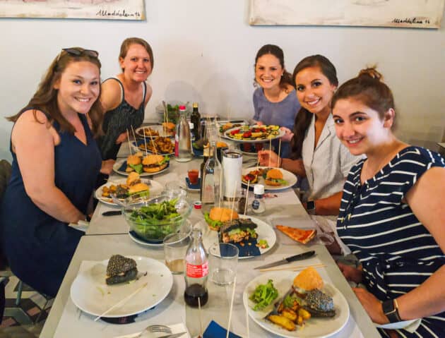 Students enjoying food at a restaurant.