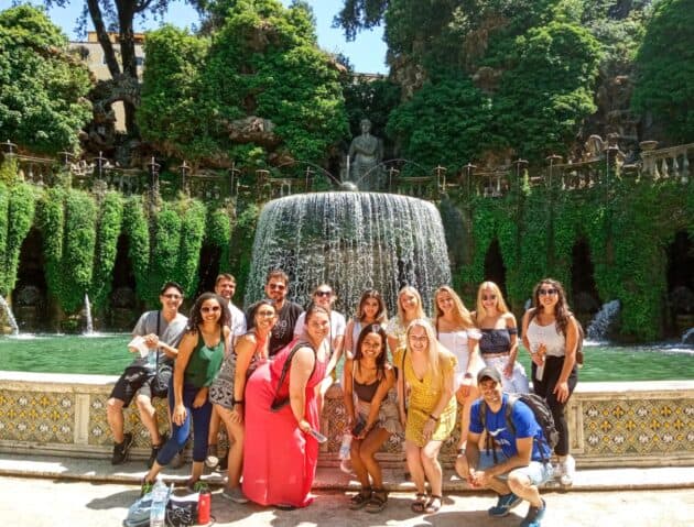 Atlantis students standing in front of a fountain.