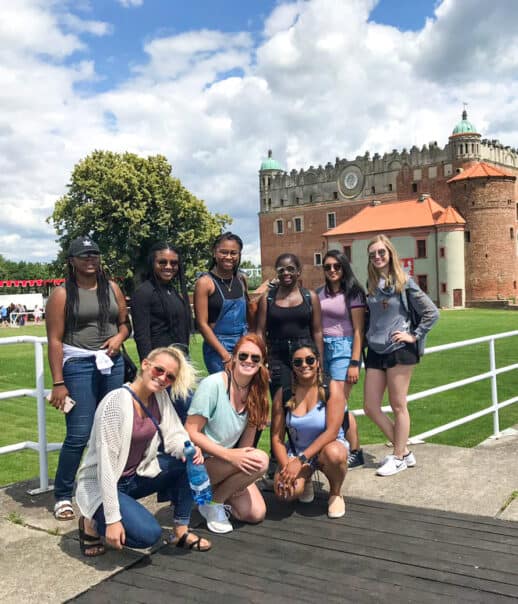 Students standing in front of a castle.