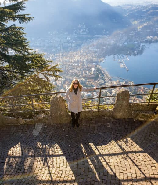 A student in front of a lookout point over the city during a program excursion.