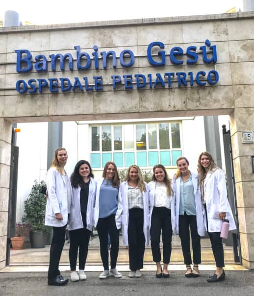 Atlantis students in front of the pediatric hospital where they are shadowing.