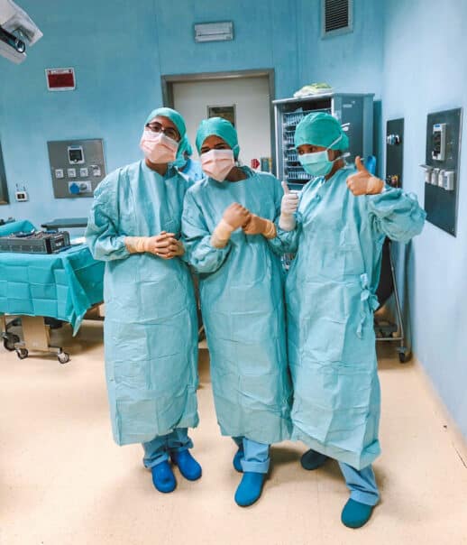 Students in scrubs and masks while shadowing.