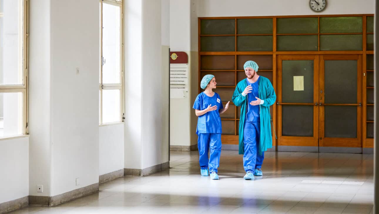 Students walking through a hospital hallway.