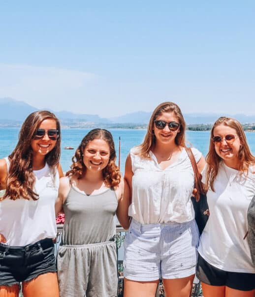 Students smiling by the ocean.