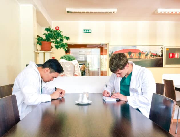 Students working on notes at a table.