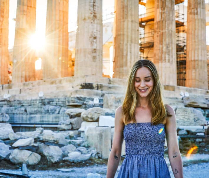 A student standing in front of a historical site.