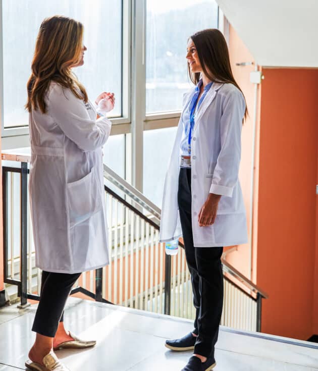 Students chatting in a hospital hallway.