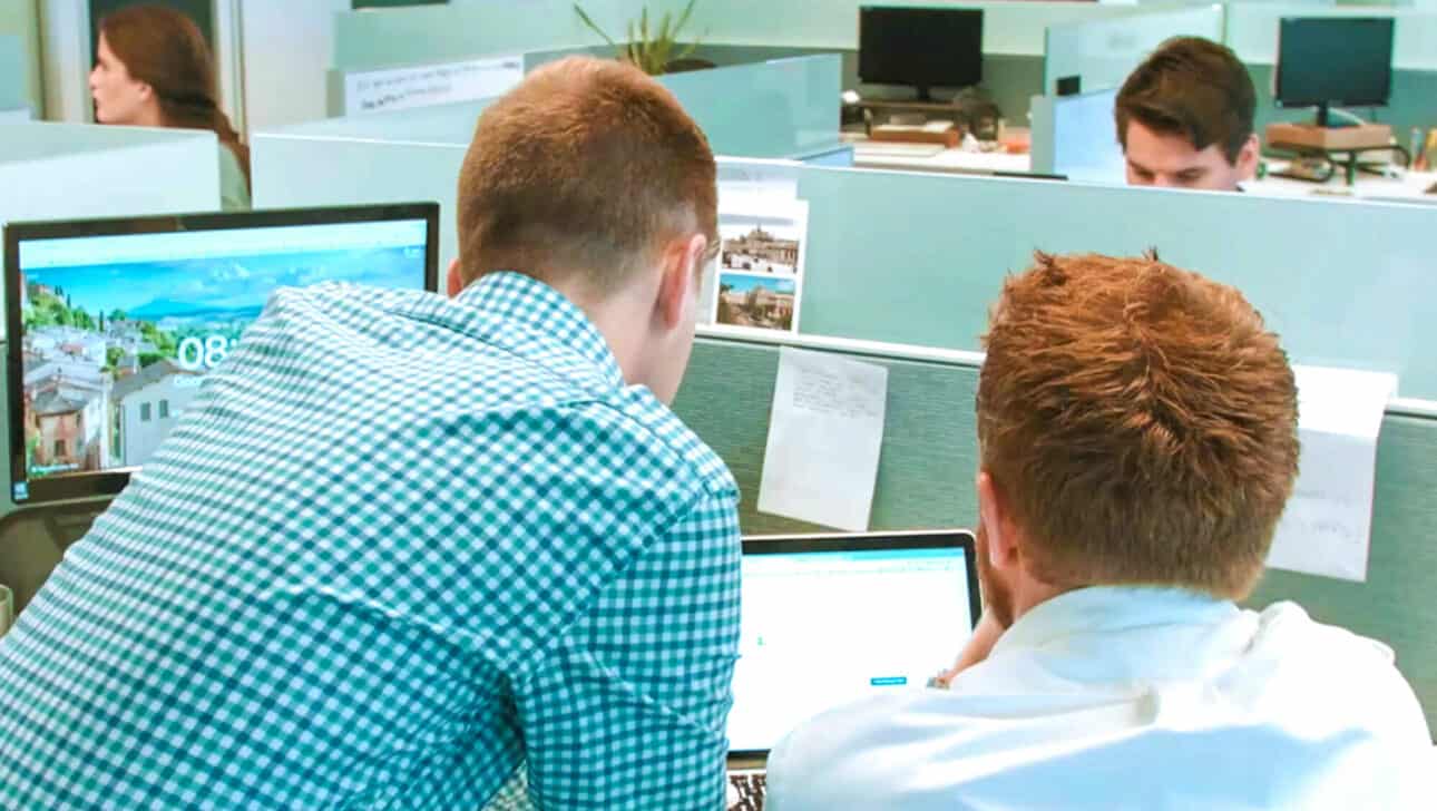 Employees working at a computer.