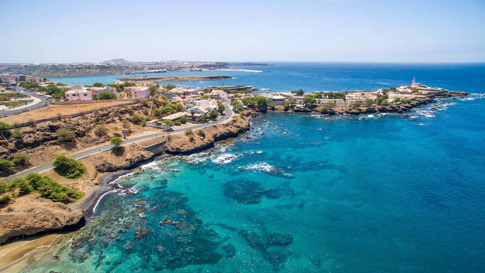 A view of a coastline with blue water.