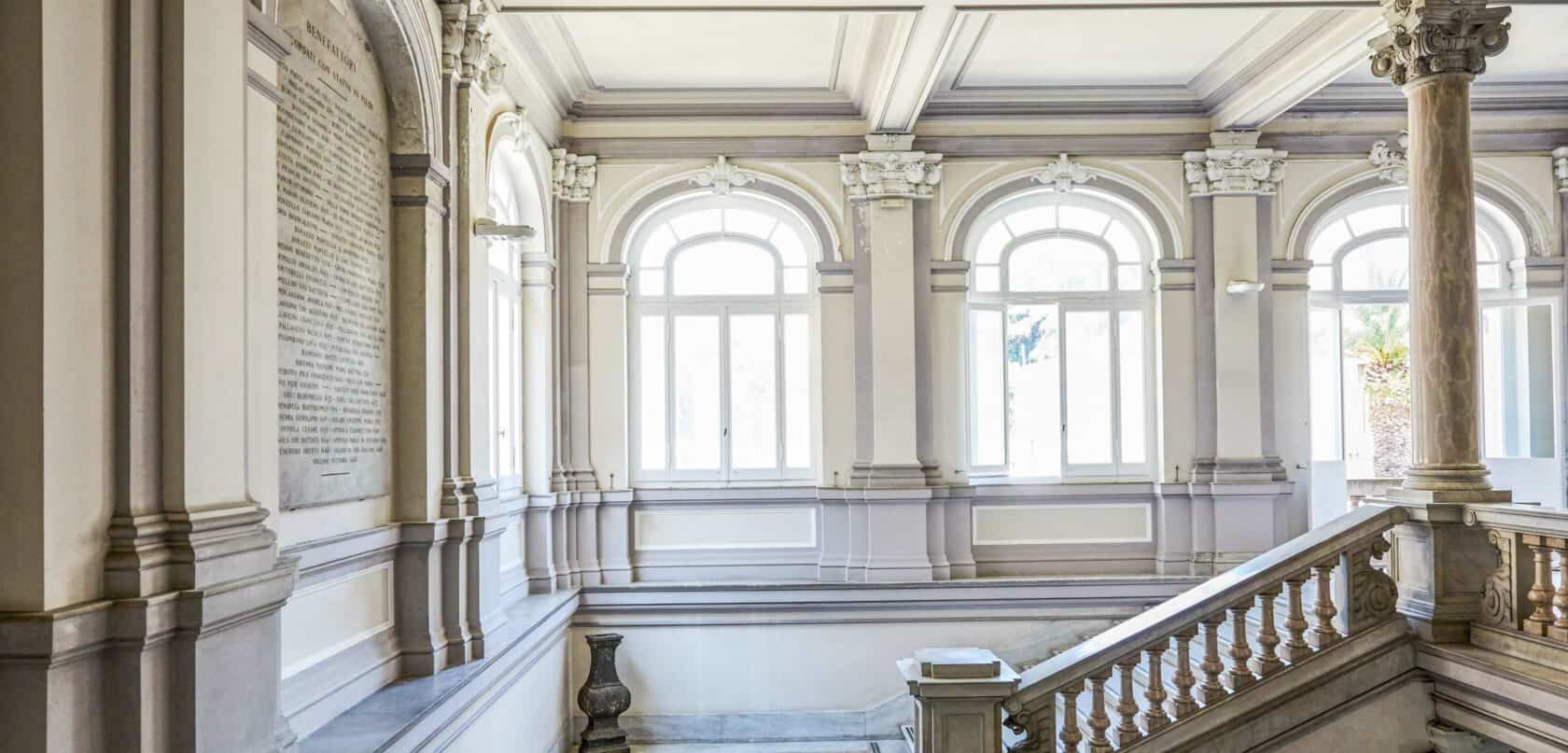 A view of the interior of a building with arched windows.