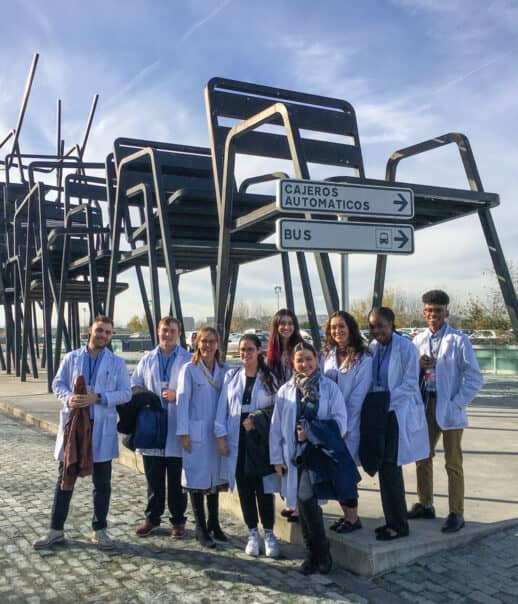 Students in front of a sculpture.