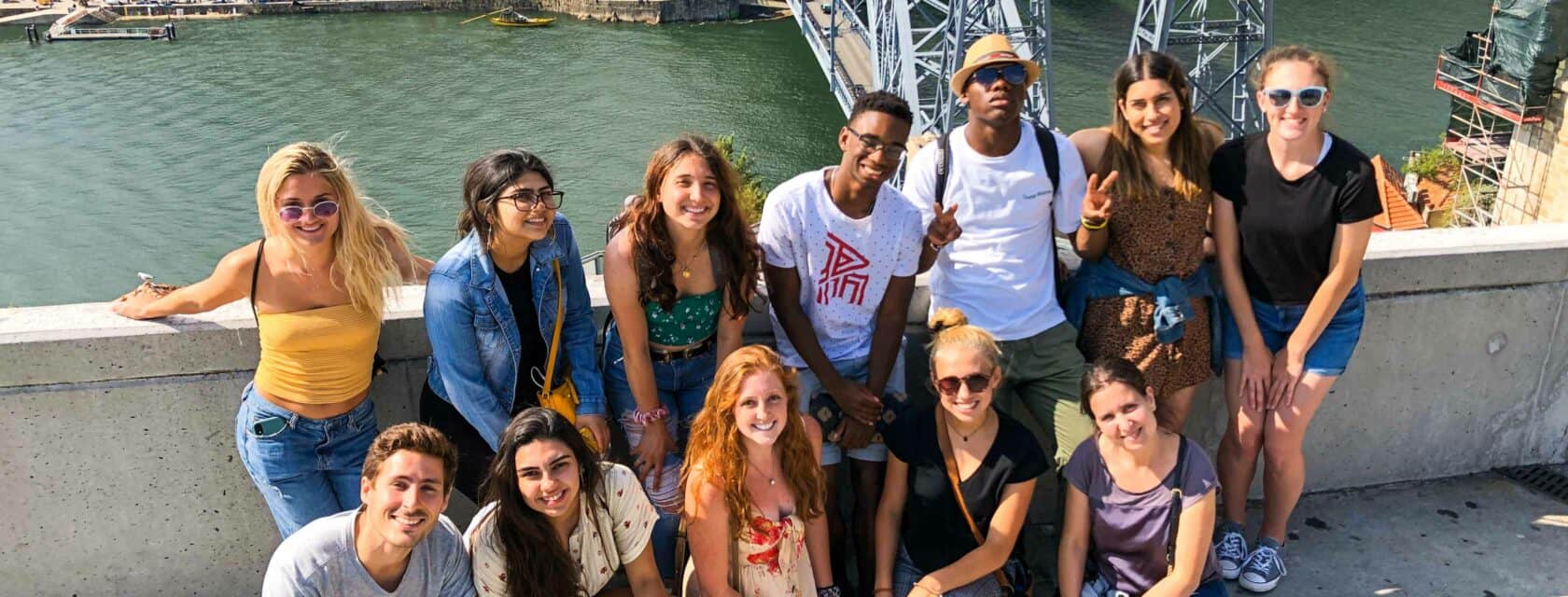 Students by a bridge while exploring the city.