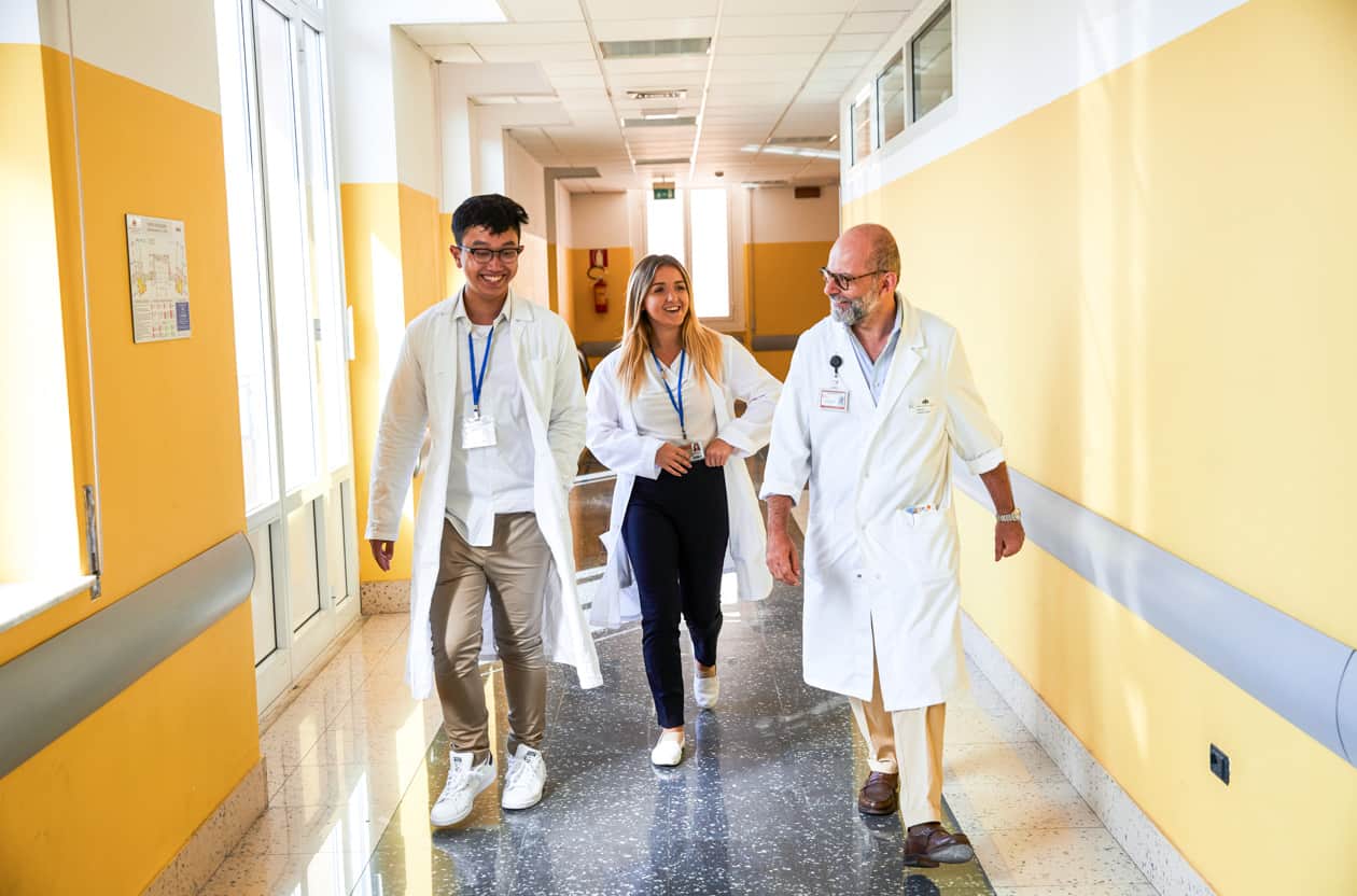 Students walking through a hospital hallway.
