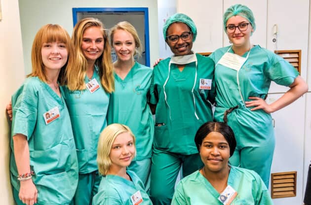 Students standing together in the hospital while shadowing.