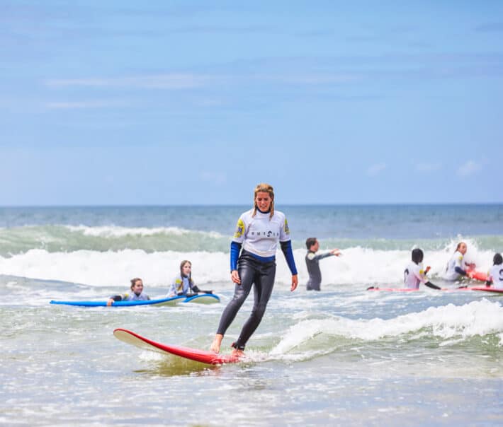 A student learning how to surf.