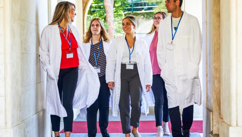 Students walking through the hallway of the hospital where they are shadowing.