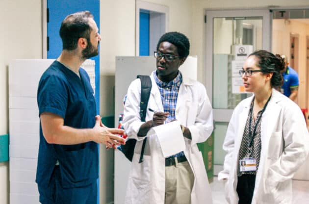 Students speaking to a medical professional in the hospital.