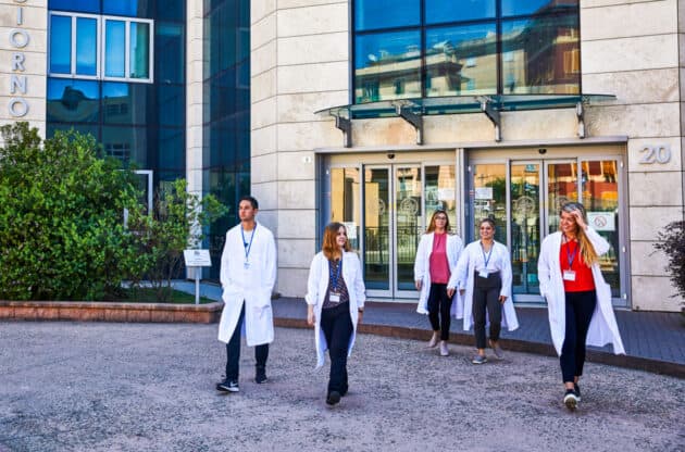 Students walking out of the entrance of the hospital.