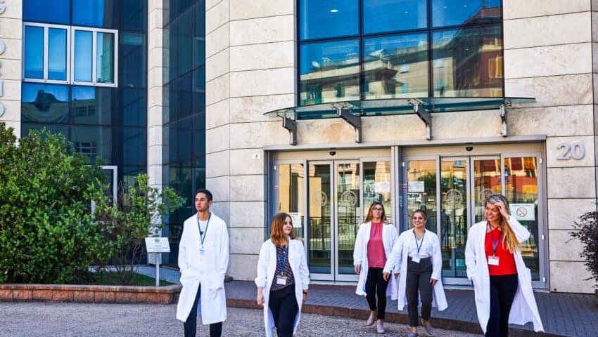 Students walking out of the entrance of the hospital.