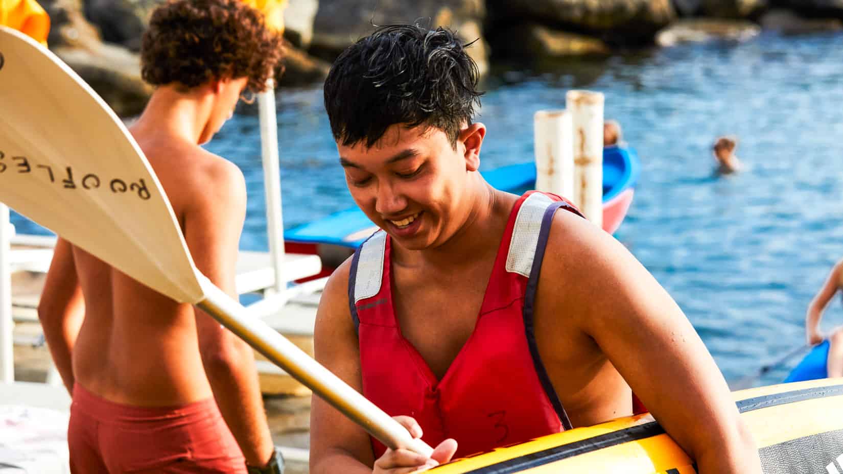 A student learning how to kayak.