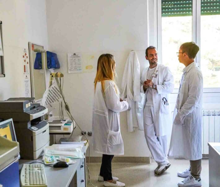 Students speaking in a hospital room.