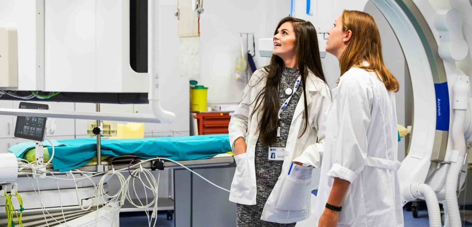 Students examining medical equipment while shadowing.