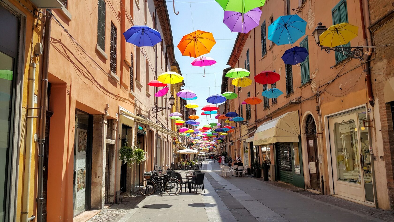 Colorful umbrellas hanging above a street in Ferrara, Italy (an Atlantis site).