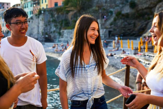 Students chatting by the oceanfront.