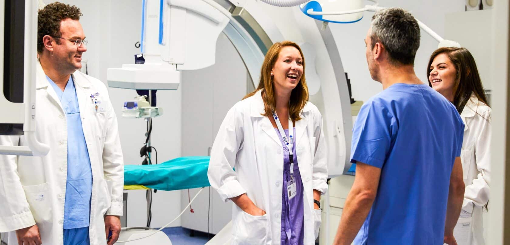Students speaking with doctors in an operating room.