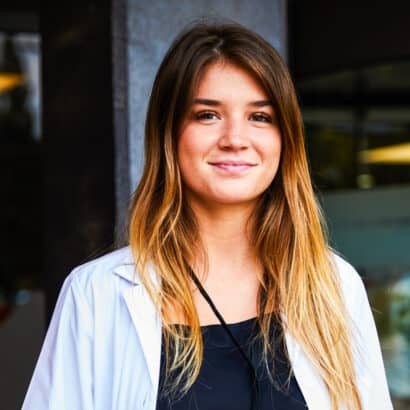 An Atlantis student standing outside the hospital where she is shadowing.